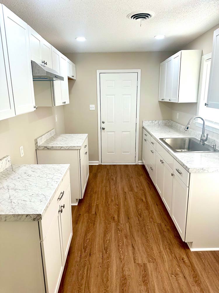 Bright bedroom with new flooring and paint in Memphis rental property for sale