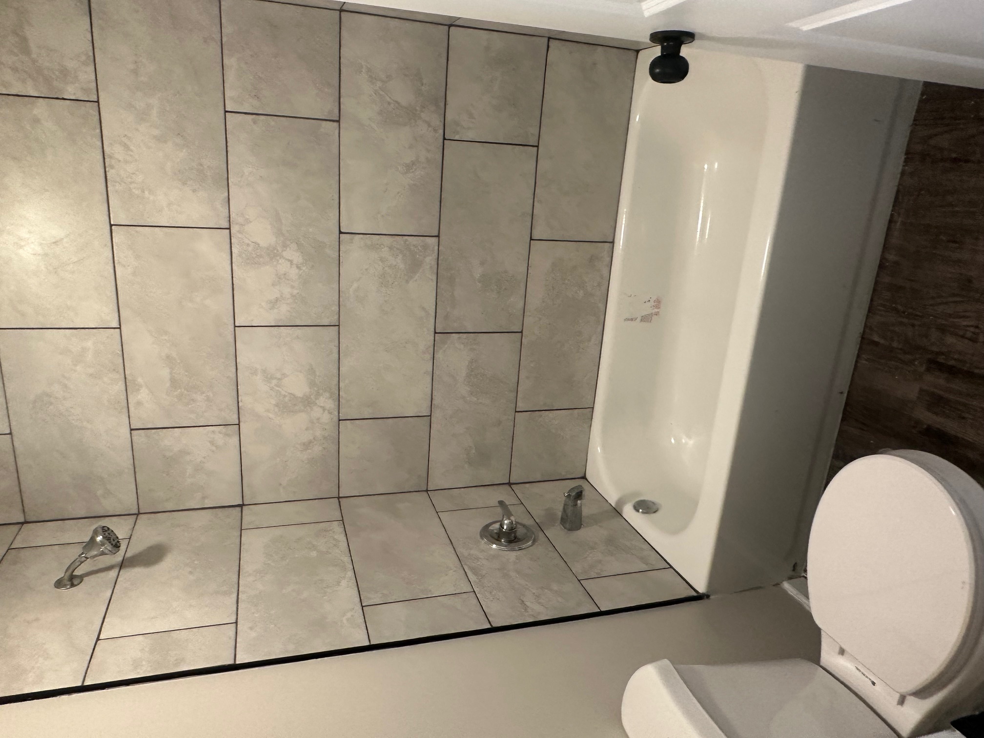 Second bedroom or office with modern accent wall and durable flooring in turnkey property 38108