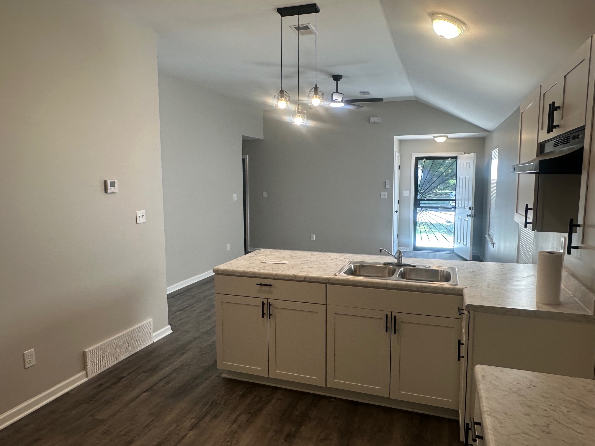 Shower and tub combo with large modern tile surround in Memphis investment home bathroom