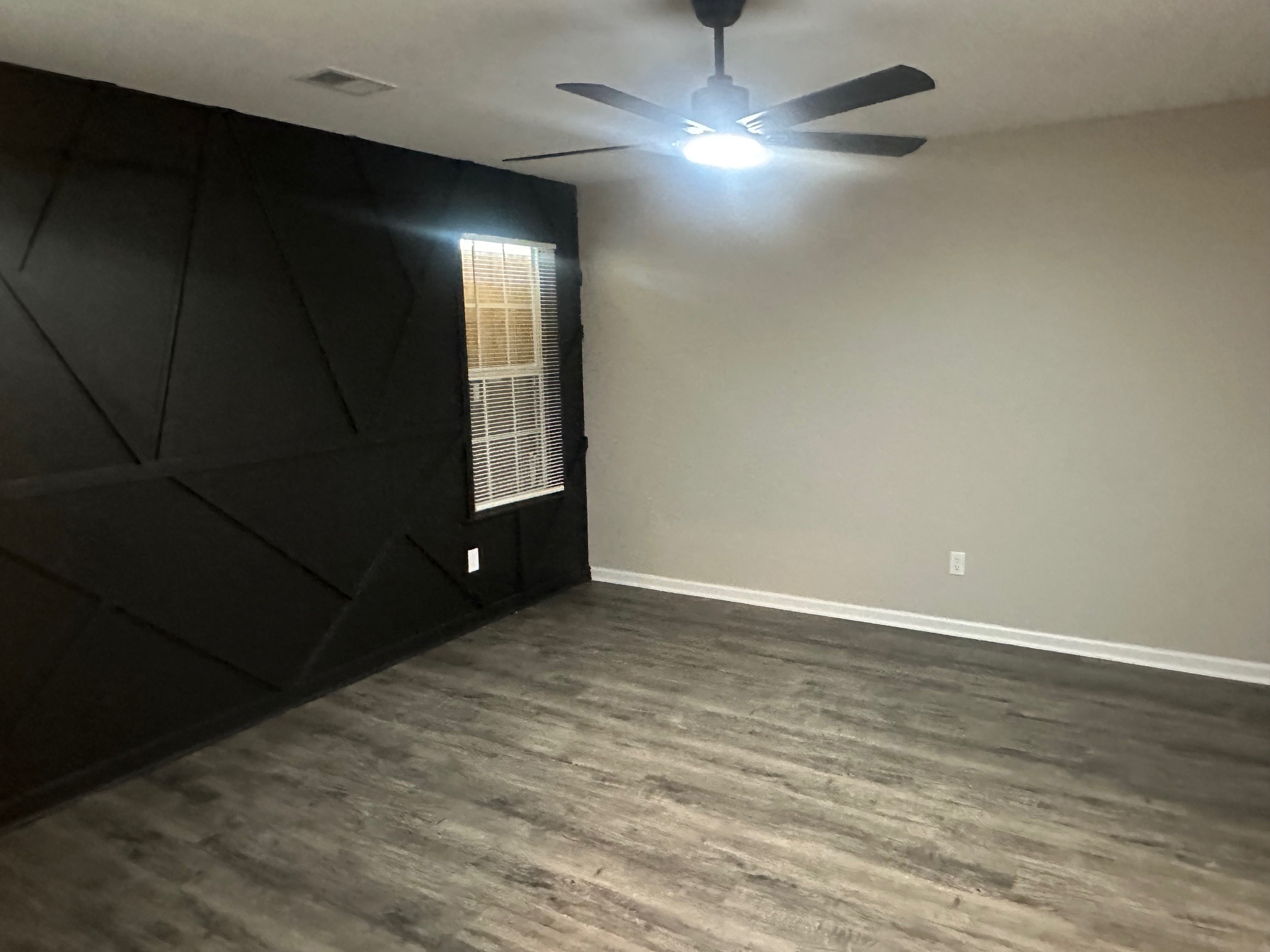 Updated half bath vanity with white cabinet and sleek oval mirror in Memphis 38108 property