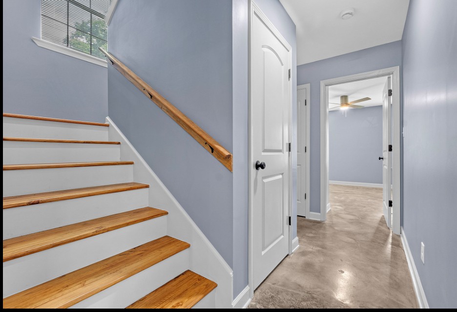 Modern stairway with natural wood accents in fully renovated Memphis TN home for sale 38107