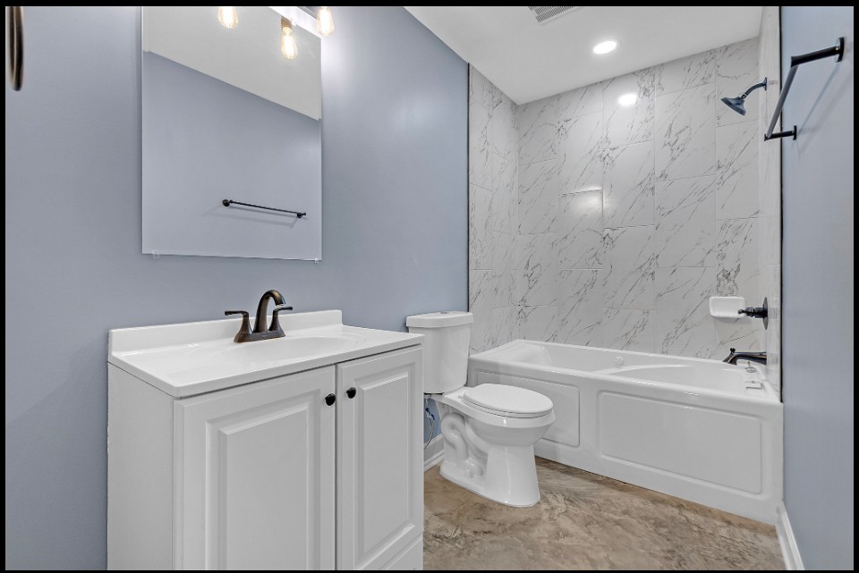 Bathroom remodel with updated vanity and tile shower combo in Memphis investment property for sale 38107