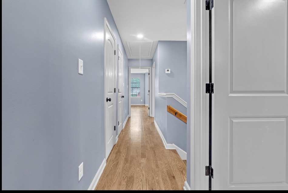 Hallway with hardwood floors and modern paint in Memphis TN house for sale 38107