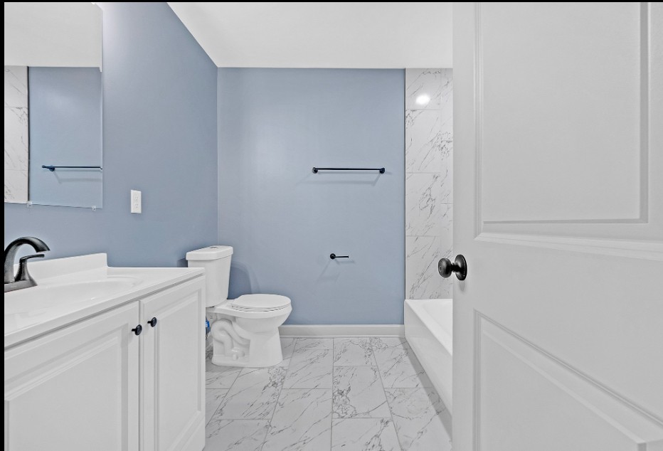 Renovated bathroom with modern tile and fixtures in Memphis rental property for sale 38107