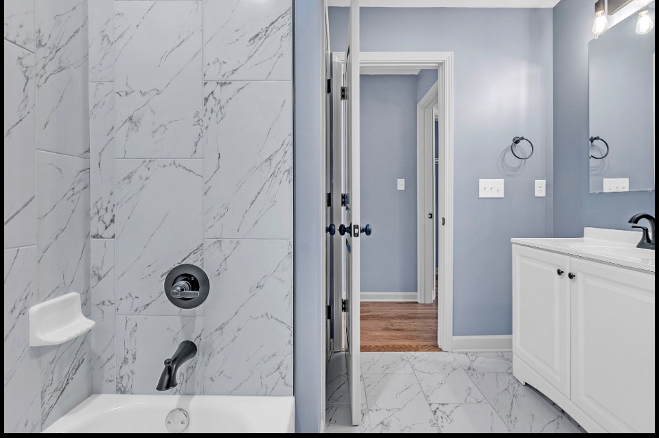 Tile tub and shower combo with updated fixtures in Memphis investment home for sale 38107