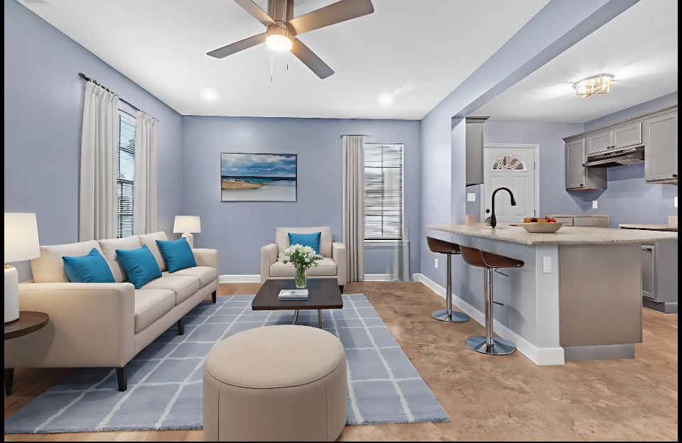 Staged living area with kitchen island and bar stools in Memphis home for sale 38107