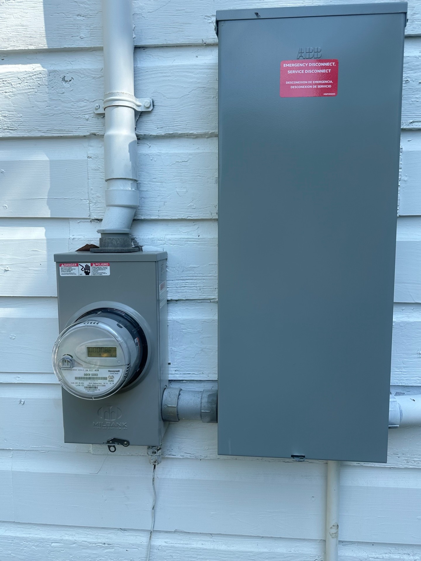 Rear entry area with white door, neutral paint, and marble tile flooring