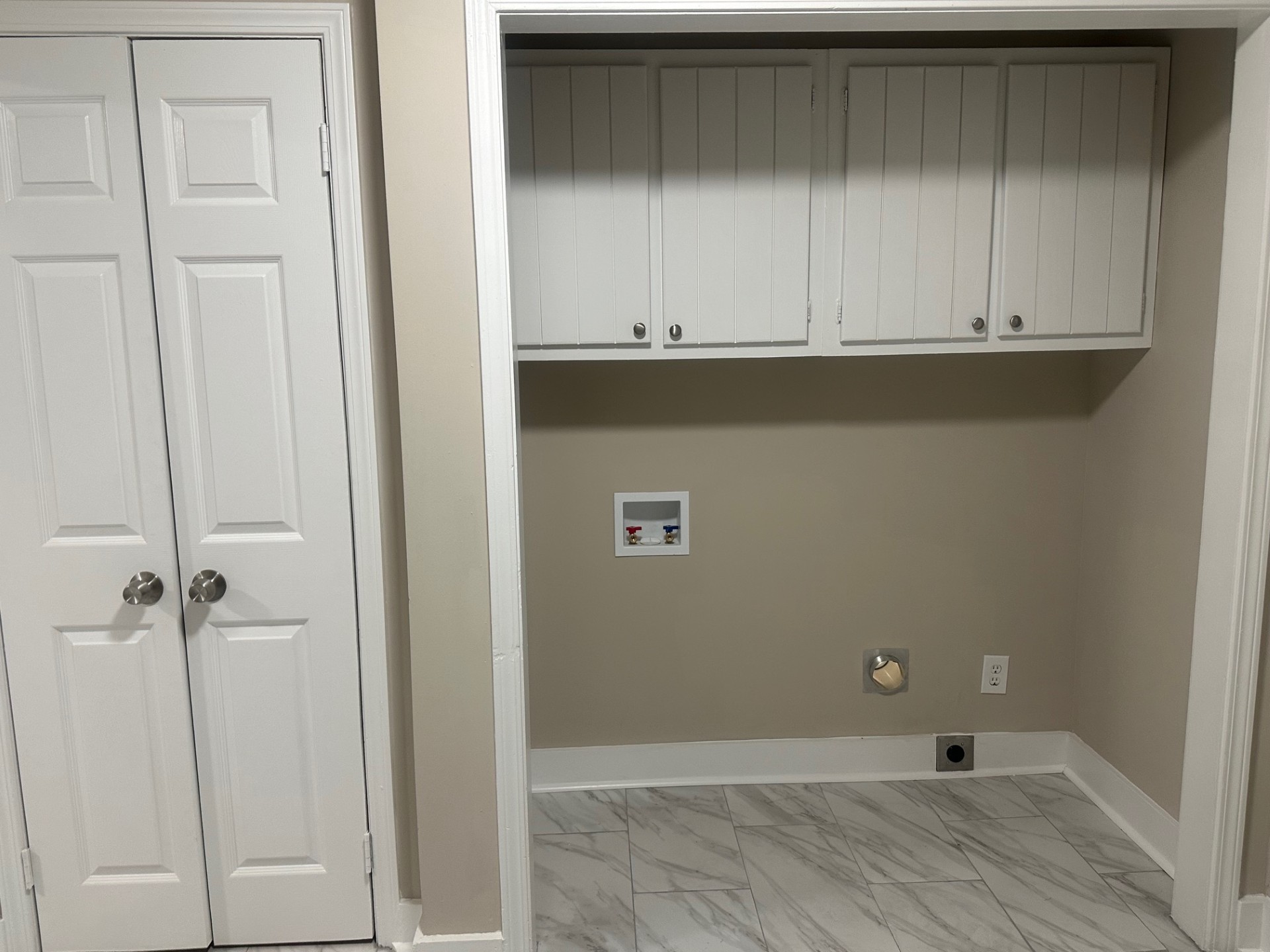 Side view of the house with lawn, mature landscaping, and tree cover