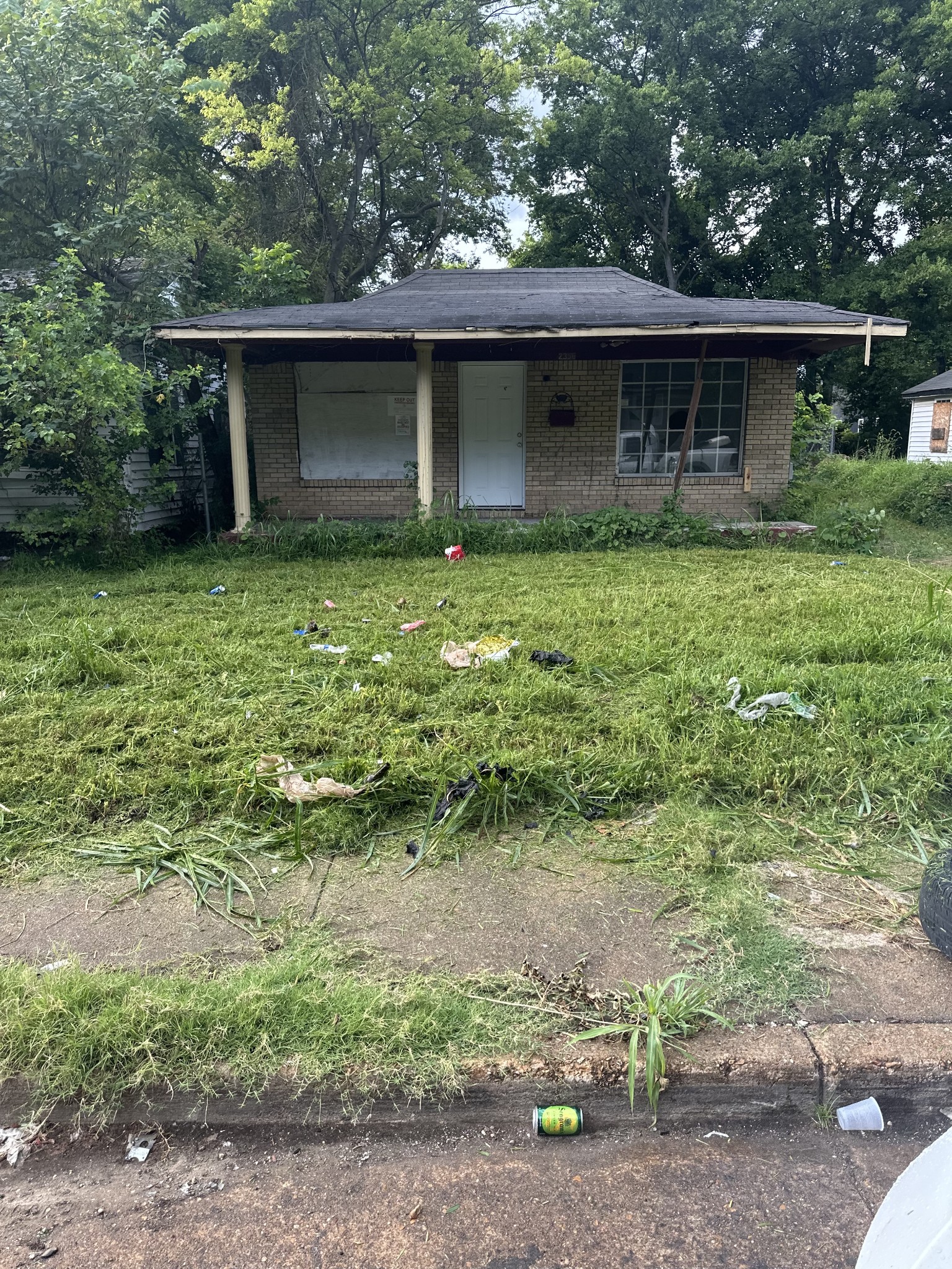 Side angle of brick house showing driveway and wall at 2356 Dexter Ave