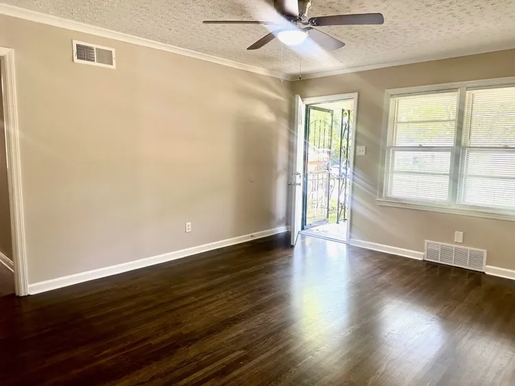 Primary bedroom with neutral paint and hardwood flooring Memphis investment home