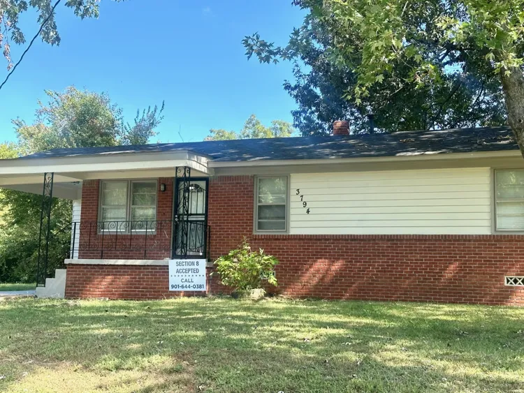 Vertical photo of clean updated kitchen cabinets and modern tile floor