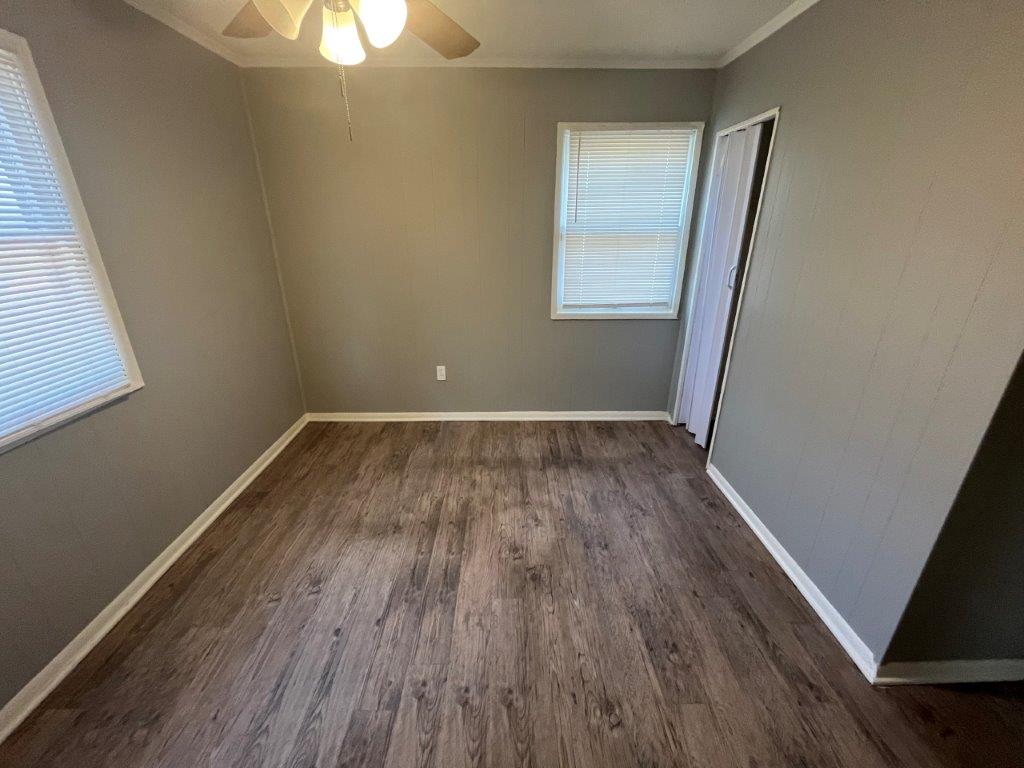 Main hallway with laminate floors in 4-bedroom Memphis property