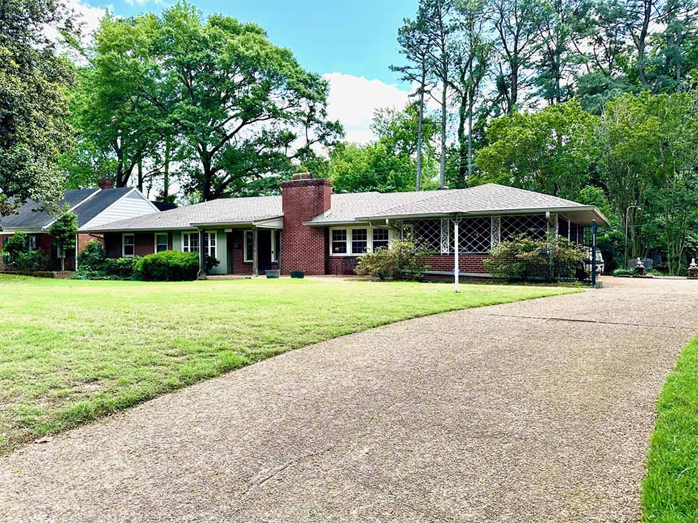 Attached garage and backyard view with gated access