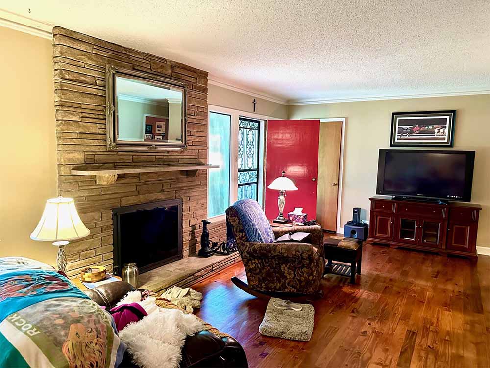 Family room with fireplace and wood floors in Memphis 38111 home
