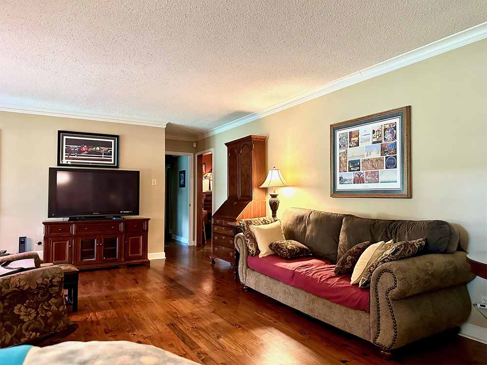 Primary bedroom with hardwood floors and generous natural light