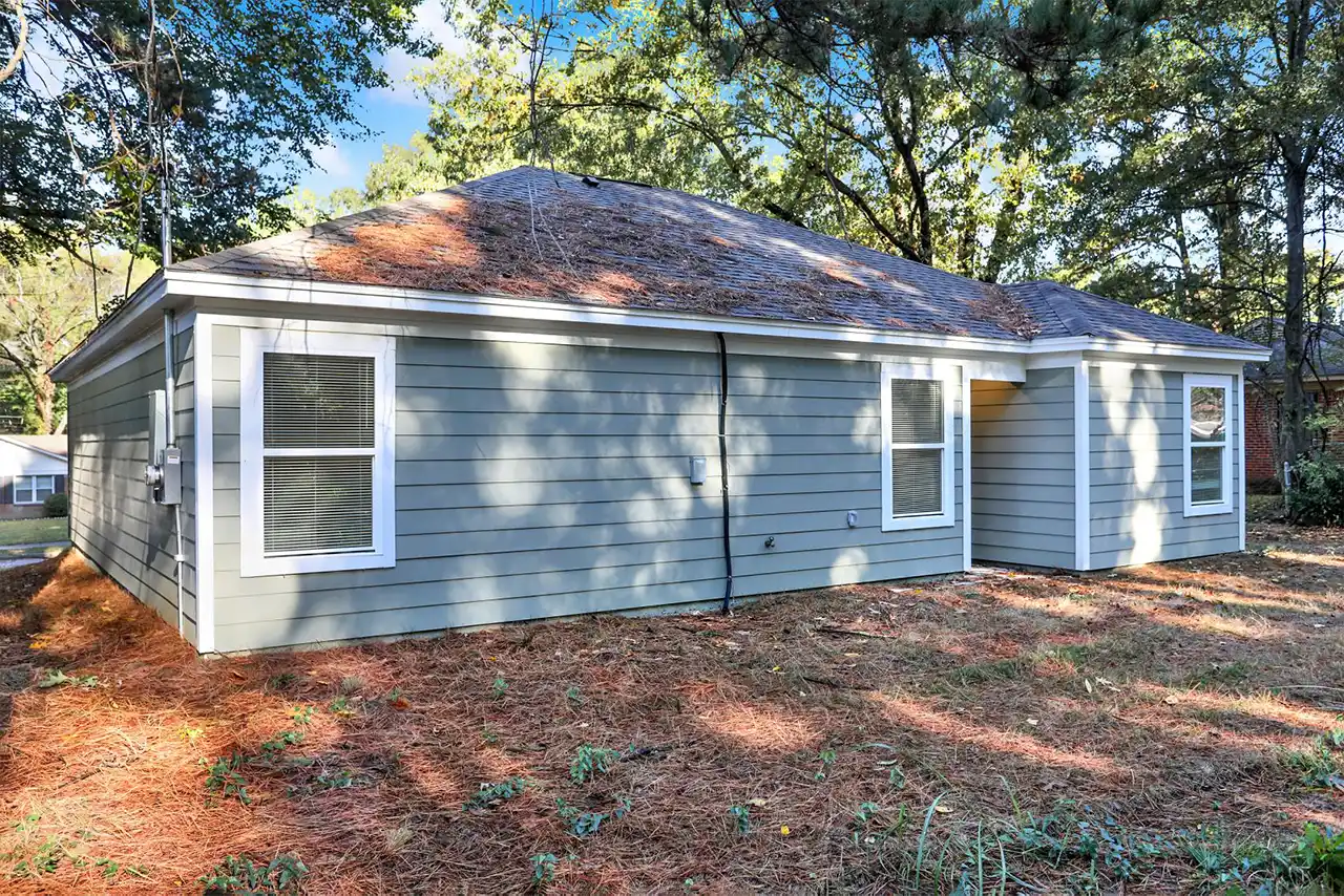 Rear exterior of home with private backyard space and back entrance