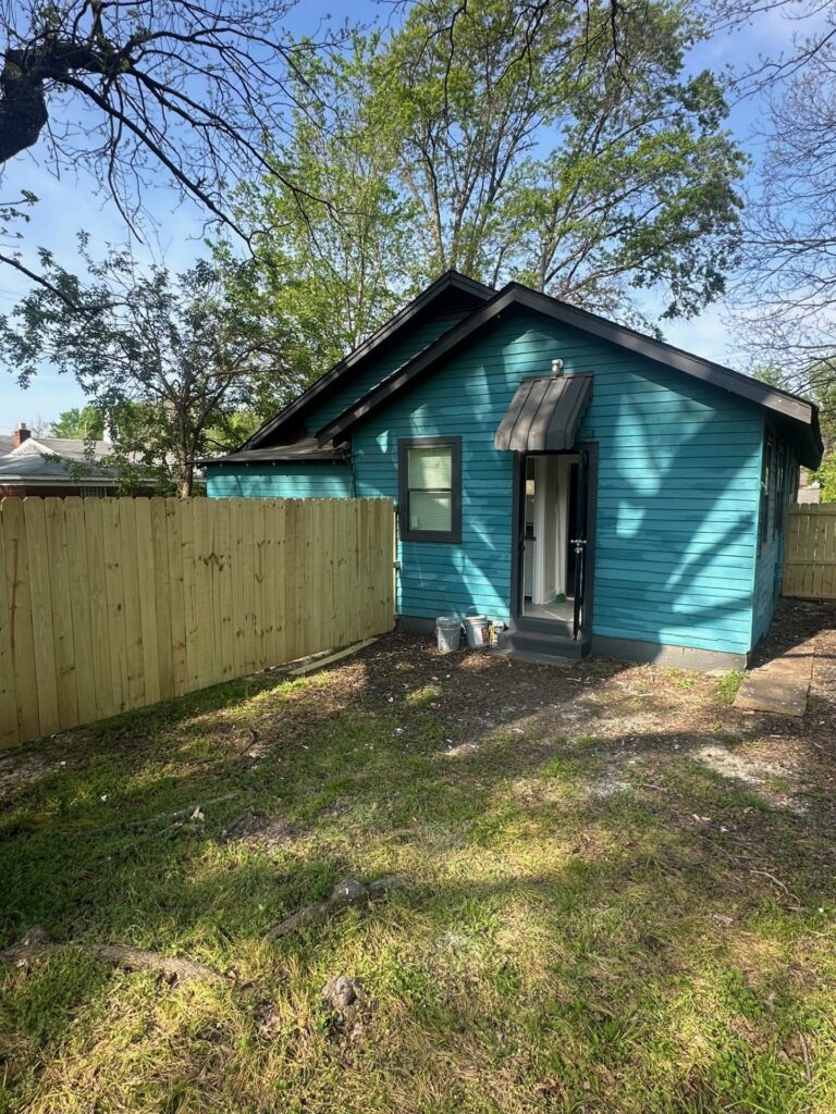 Backyard area showing property's freshly painted exterior
