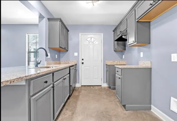 Renovated kitchen with granite counters and grey cabinets in Memphis investment property for sale 38107