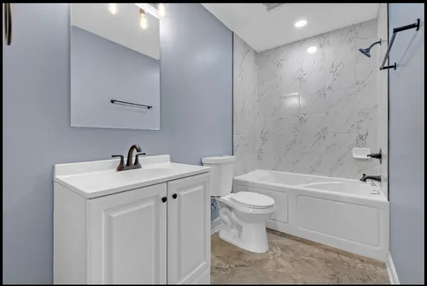 Bathroom remodel with updated vanity and tile shower combo in Memphis investment property for sale 38107