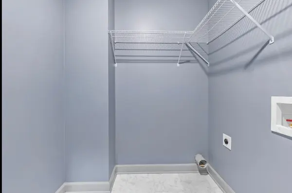 Laundry room with shelving and washer dryer connections in Memphis real estate investment 38107