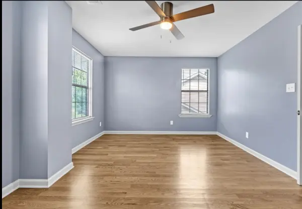 Large bedroom with ceiling fan and dual windows in Memphis home for sale 38107