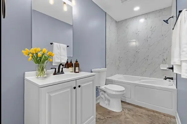 Stylish bathroom with tub shower and fresh decor in renovated Memphis home for sale 38107