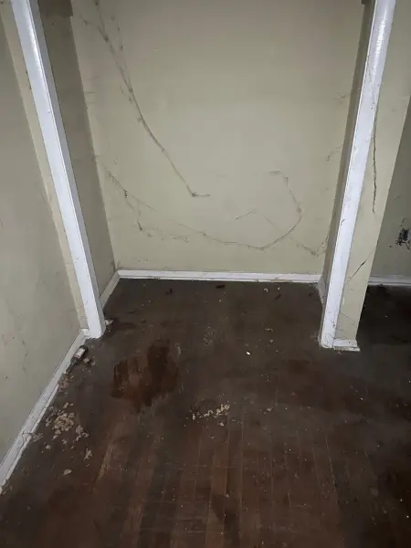 Severe fire damage in hallway with insulation and debris scattered