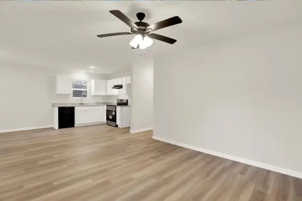 Living area with view toward open kitchen layout and luxury vinyl flooring