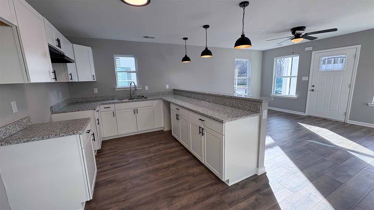 Bright kitchen with stainless steel appliances and granite countertops