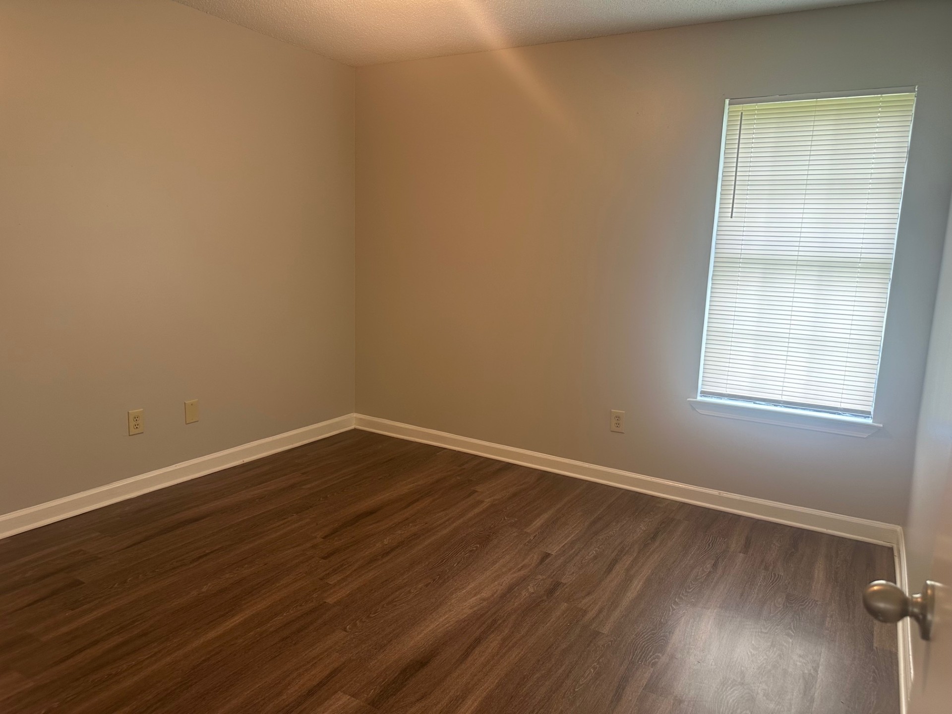Hallway with Modern Flooring and Fresh Paint in Memphis Turnkey Home
